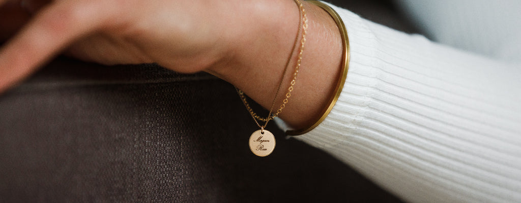Name Megan Rose engraved on our bestselling personalised Insignia Disc Gold and Silk Bracelet.. Free custom engraving online at Wanderlust Life Jewellery.
