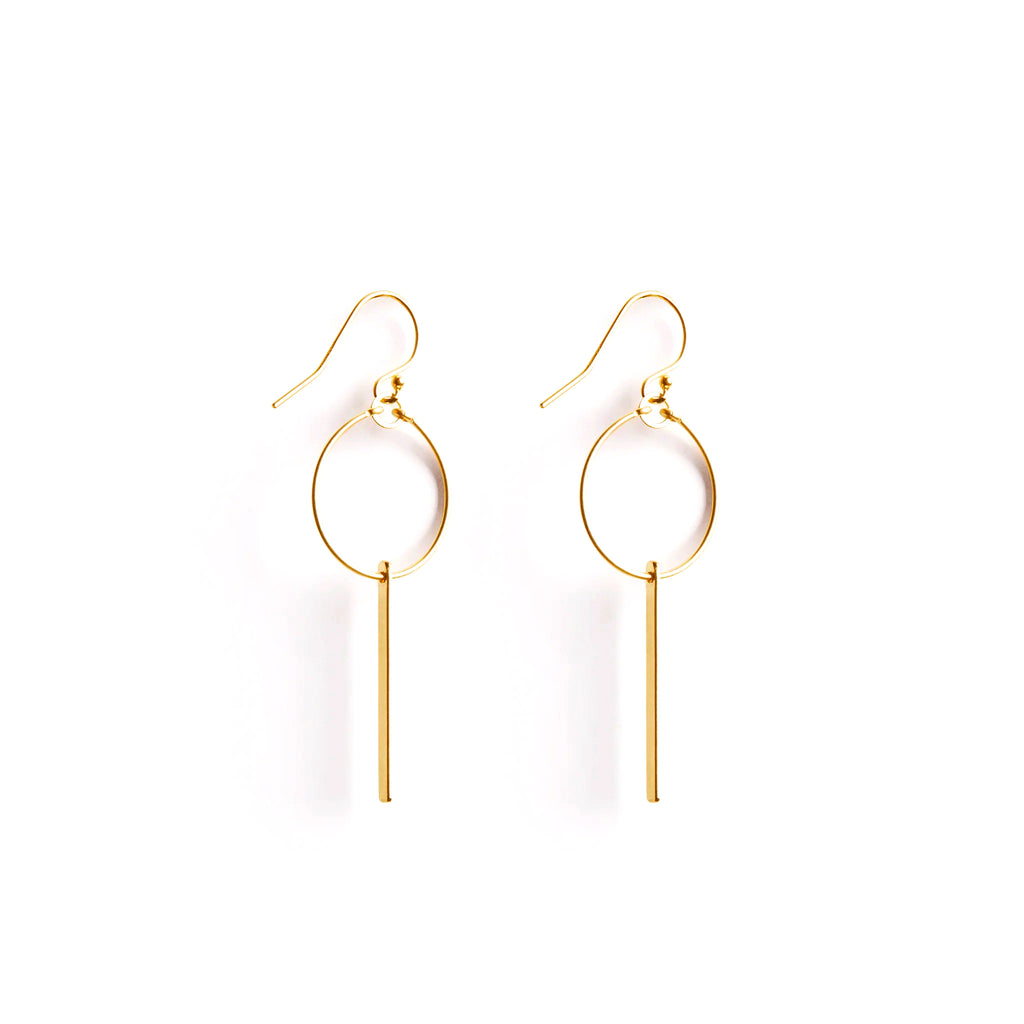 Wanderlust Life Ethically Handmade jewellery made in the UK. Minimalist gold and fine cord jewellery. Aktis sculptural hoop earring with hoop and drop gold bar.
