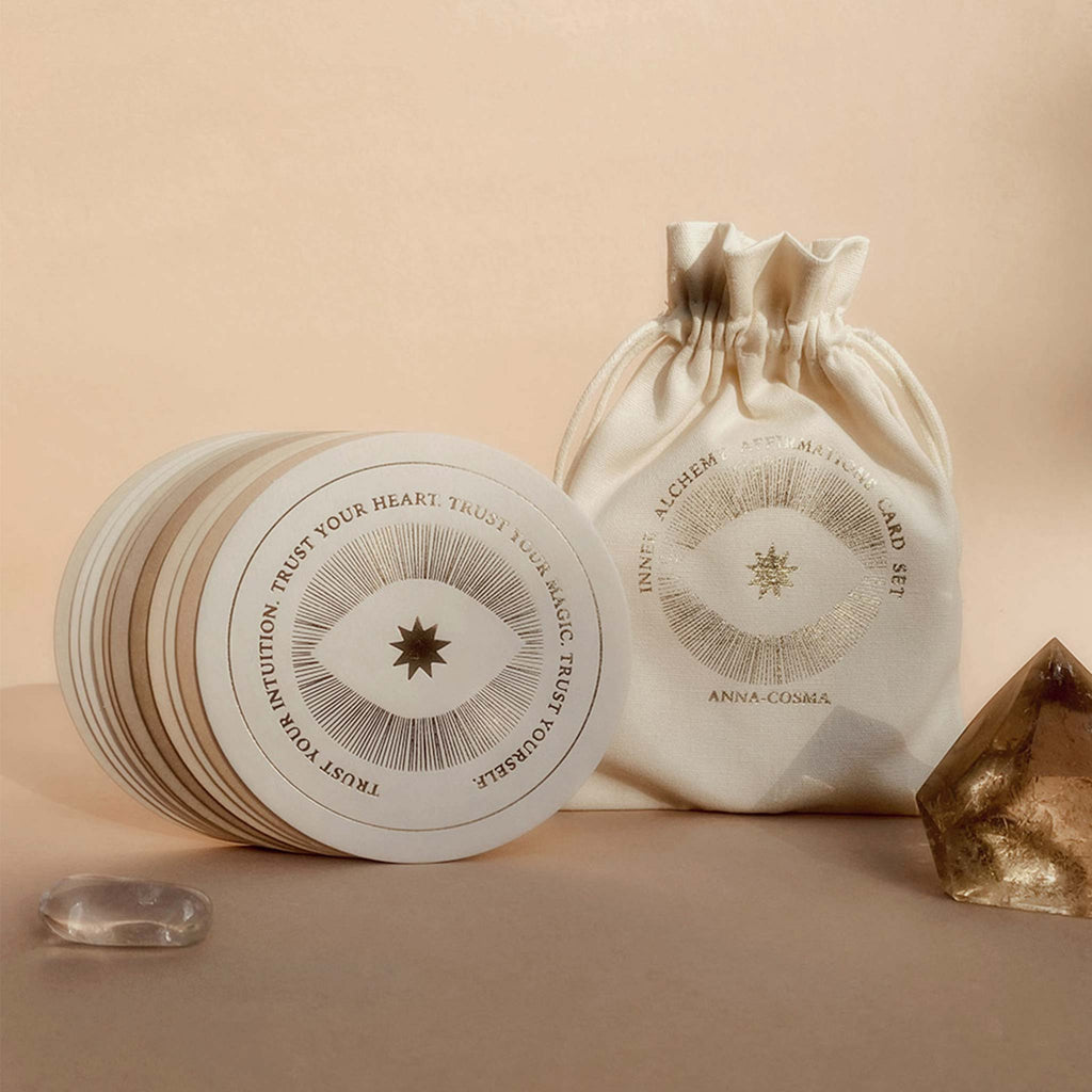 A set of circular cards with gold-foil embossing. Each card has a mantra or affirmation, and they come enclosed in a linen drawstring bag.