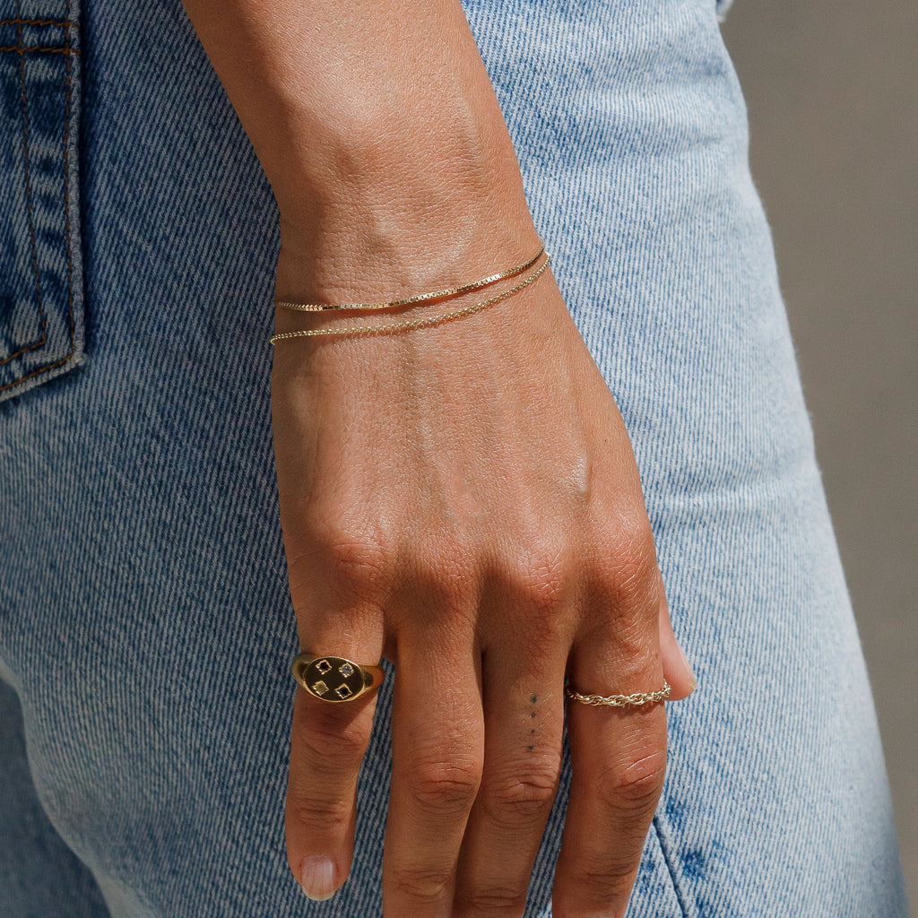 Wanderlust Life Ava Box Chain 9k gold bracelet. Styled with the Lula Belcher chain 9k gold bracelet, Stargazer gemstone signet ring, and Dali rope chain. Designed and handcrafted in the UK.  