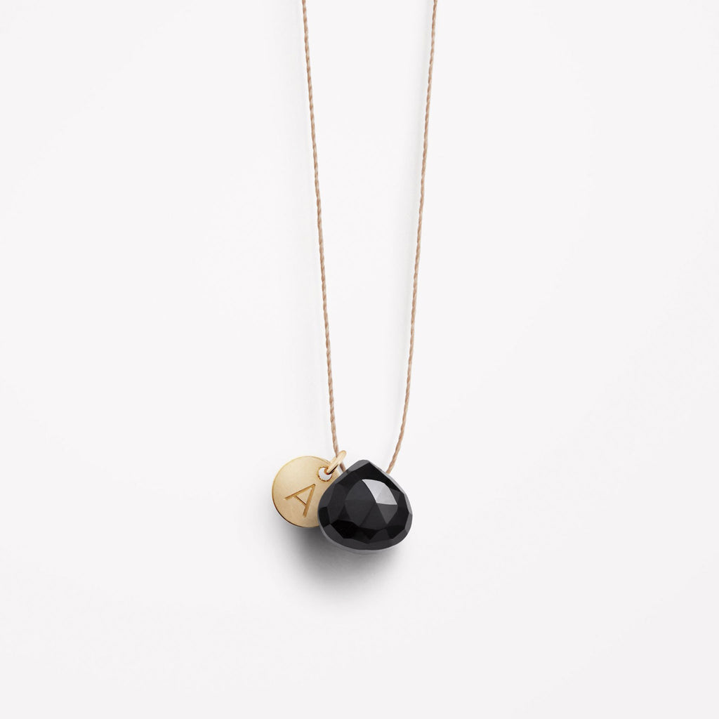 Wanderlust Life Ethically Handmade jewellery made in the UK. Minimalist gold and fine cord jewellery. Personalised Black Spinel gemstone fine cord necklace with gold personalised tag.