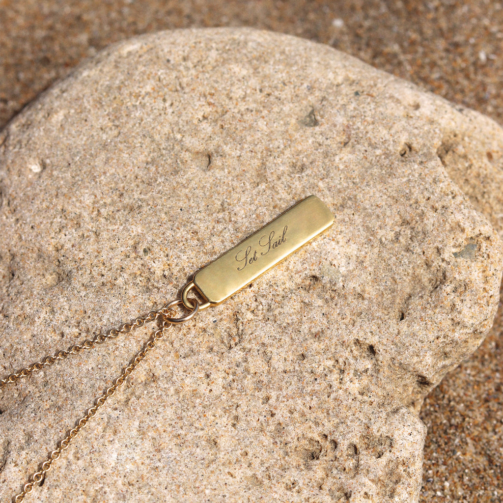 The mantra Set Sail is engraved into a gold bar pendant. A design inspired by the properties of water signs and the element of water, this customised necklace makes the perfect gift for water signs. Sustainably made in the UK by our Wanderlust Life Global Artisan Partners; designed and engraved in our Devon studio. Shop the Elemental collection and customise your jewellery with our complimentary engraving service.