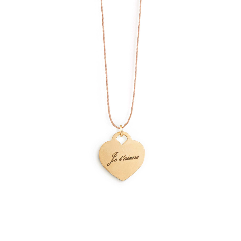 The Love Notes Fine Cord Necklace - our signature fine cord is minimal and simple; it's paired with a gold fill heart shaped pendant. Engraved with the phrase 'je t'aime' The pendant can be customised on both sides with free engraving.