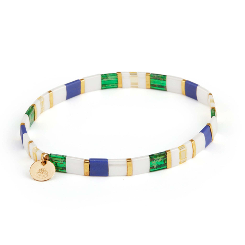 The Fez Layering Bracelet features white, green, blue and gold Tila beads, alternating into a Moroccan inspires tile pattern. Completed with a branded Wanderlust Life tag with our signature gemstone. Elasticated for an adjustable fit.