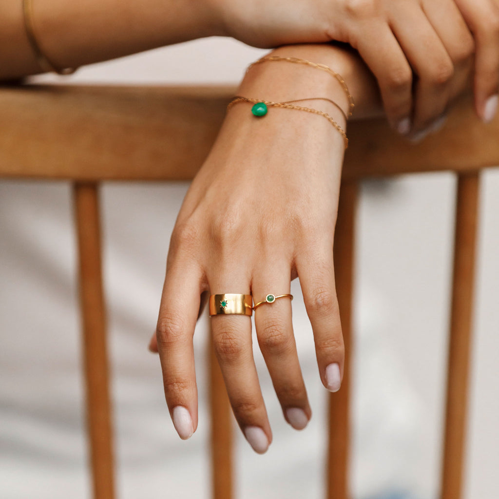 Inspired by a cigar band, the Sigaro ring is a substantial statement brand ring featuring a star set green onyx gemstone. Styled with other shades of green, the emerald mano ring and birthstone bracelet are great styling companions. 14k gold vermeil gemstone jewellery.