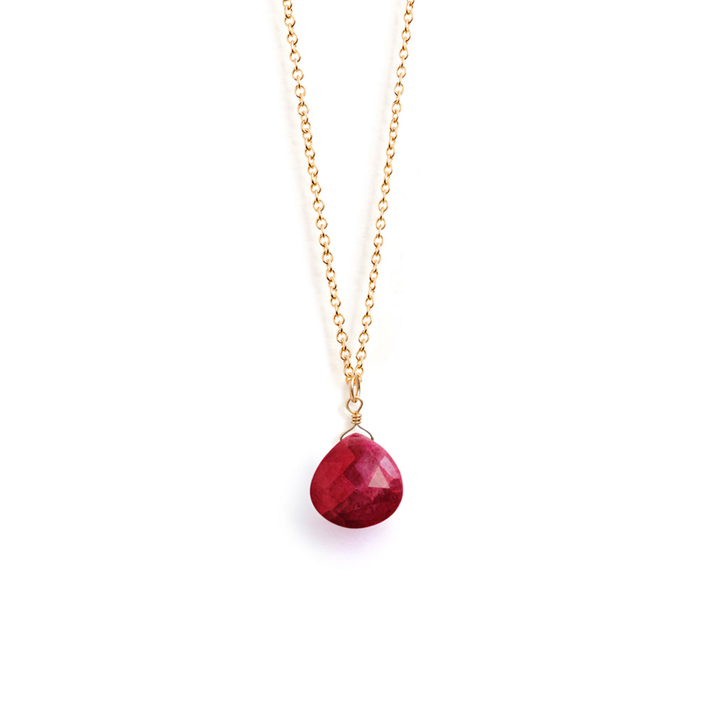 A faceted ruby gemstone floats on a minimal fine gold chain. A meaningful birthstone gift for July birthdays, designed and handcrafted in our Devon studio.