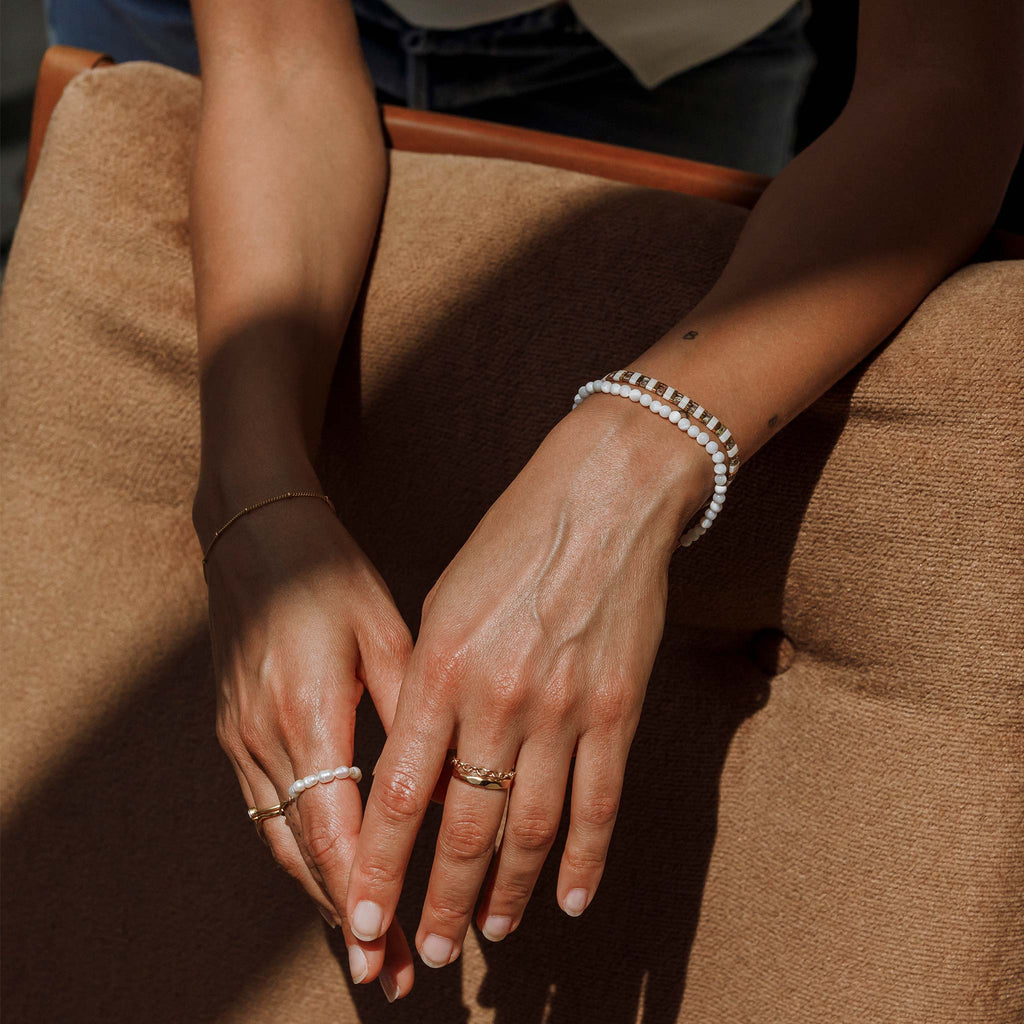 The bestselling Terrazzo Slider Bracelet. Alternating white and gold tile beads create a patterned, beaded bracelet. Neutral, earthy tones with glittering gold can be effortlessly paired with gold bracelets and pearl jewellery.