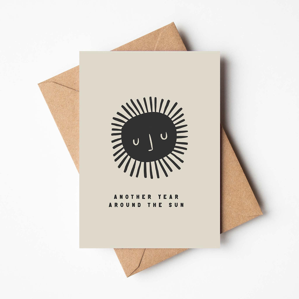 Birthday greetings card in monochrome colours reads 'another year around the sun'. Blank inside and brown envelope inlcuded.