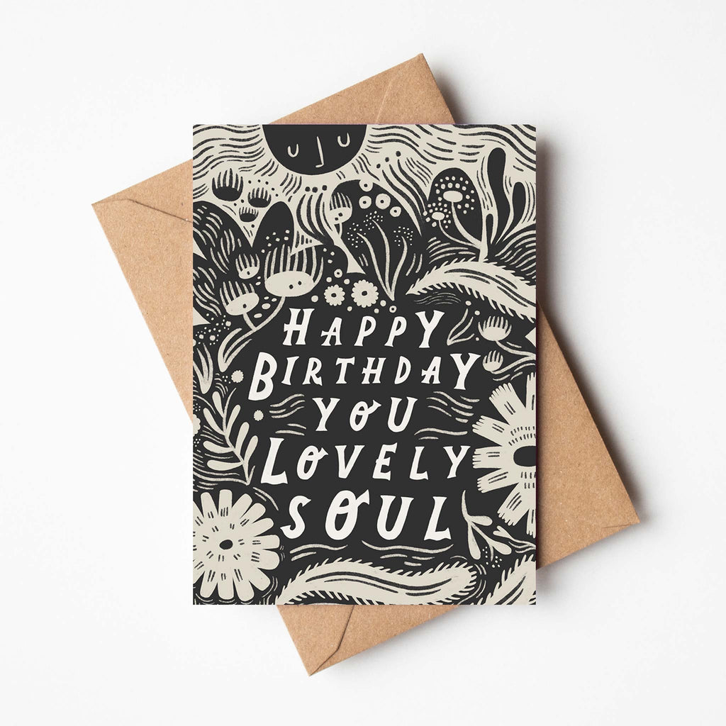 In a black and white, monochromatic colour scheme, this illustrated greetings card reads 'happy birthday you lovely soul'. In the artist Lauren Marina's distinctive, modern style. Shop birthday cards at Wanderlust Life.