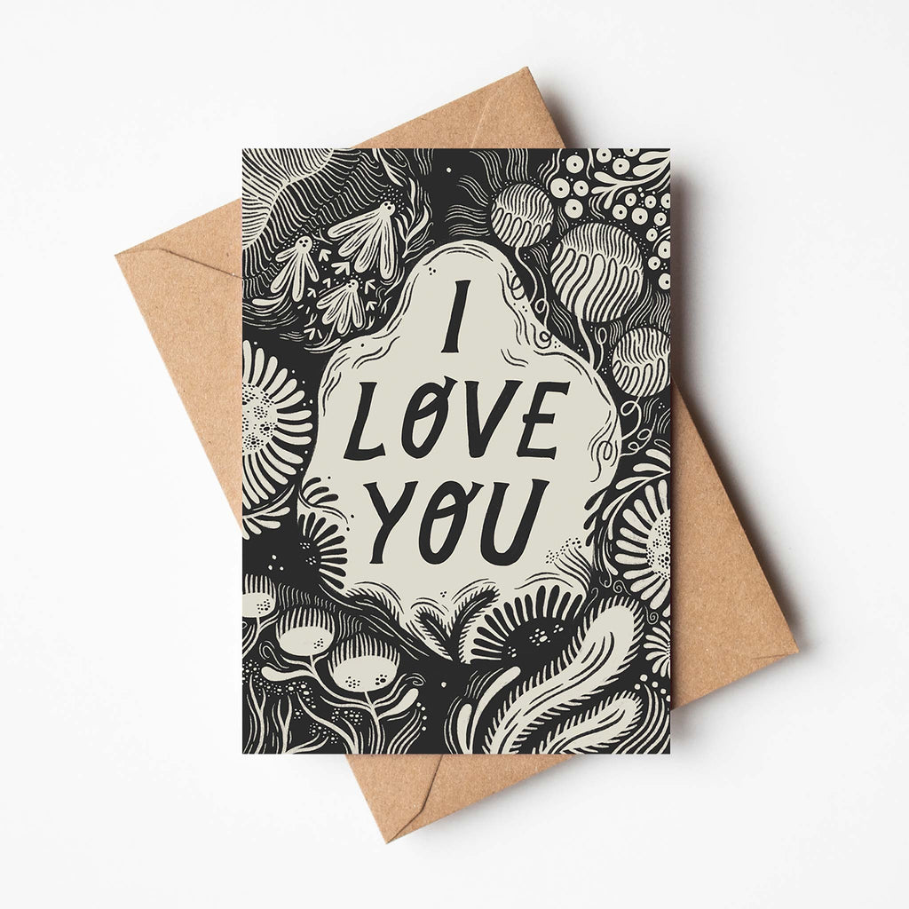 Illustrated card reading 'I love you' with bold font and monochrome colours in a nature-inspired design.