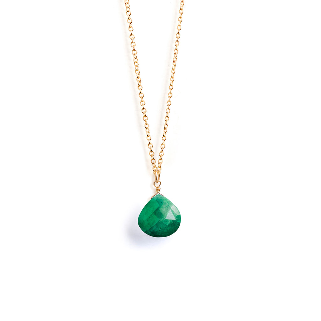 A faceted emerald gemstone delicately floats on a minimal fine gold chain. Designed and handcrafted in our Devon studio with gold fill.
