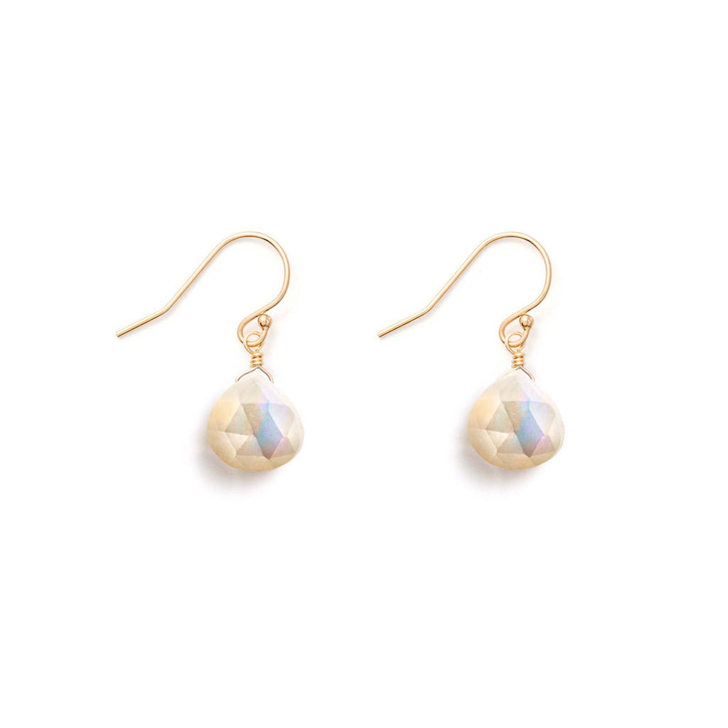 Mother of Pearl gemstones hang from gold-fill earwires. These mother of pearl earrings feature our signature, faceted shape in our iconic Isla Drop Earrings.