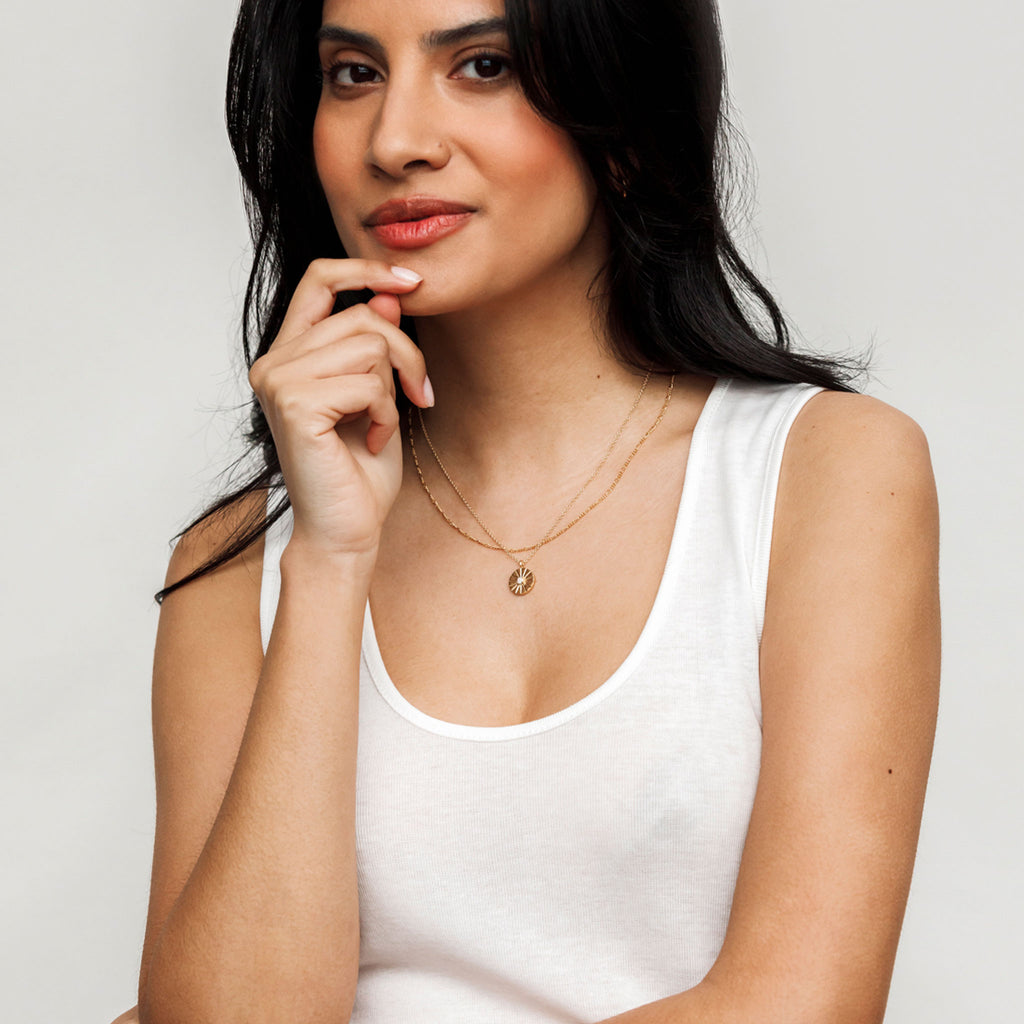 Sofia Layering Chain Necklace. This petite Figaro chain necklace is styled layered with the Opal Mini Sundial Necklace, the October Birthstone Necklace. Made with 14k gold fill, quality gold jewellery that doesn't tarnish or wear back to silver; as seen in the Independent. Affordable, quality gold jewellery. Minimal necklace on an adjustable length chain perfect for layering.