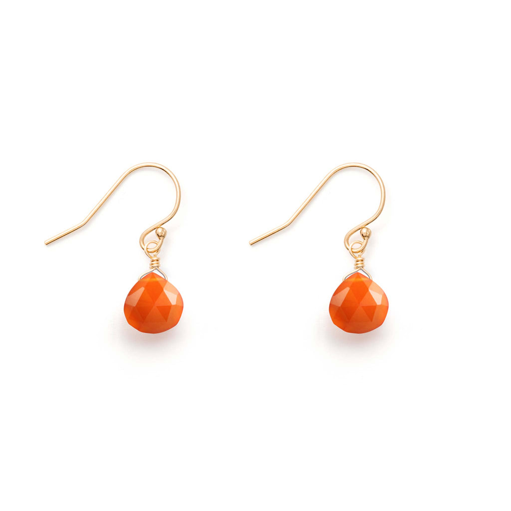 Sunset orange Carnelian gemstones hang from gold ear wires, forming gemstone drop earrings.