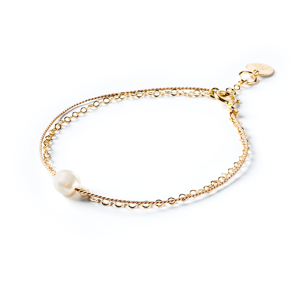 Wanderlust Life gold and silk bracelet with white freshwater pearl. Handmade jewellery in the UK.