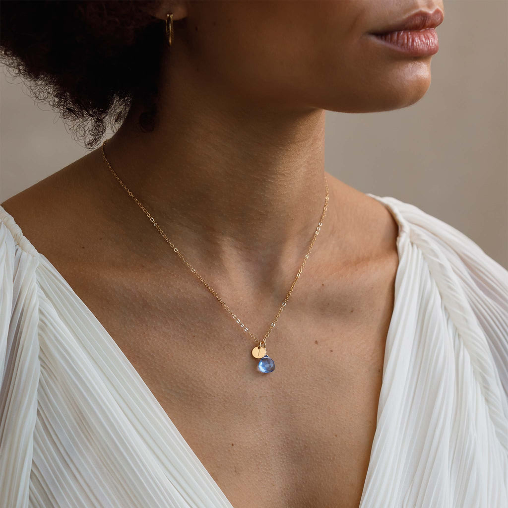Personalised with a hand-stamped initial tag with the letter I, this California Blue Quartz Gemstone hangs as a pendant from a minimal gold-fill necklace. The chain is adjustable, ideal for necklace layering. Shop personalised initial jewellery.