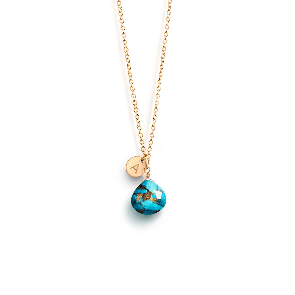 Personalised with a hand-stamped initial charm, a mohave turquoise gemstone hangs from a minimal 14k gold fill chain.