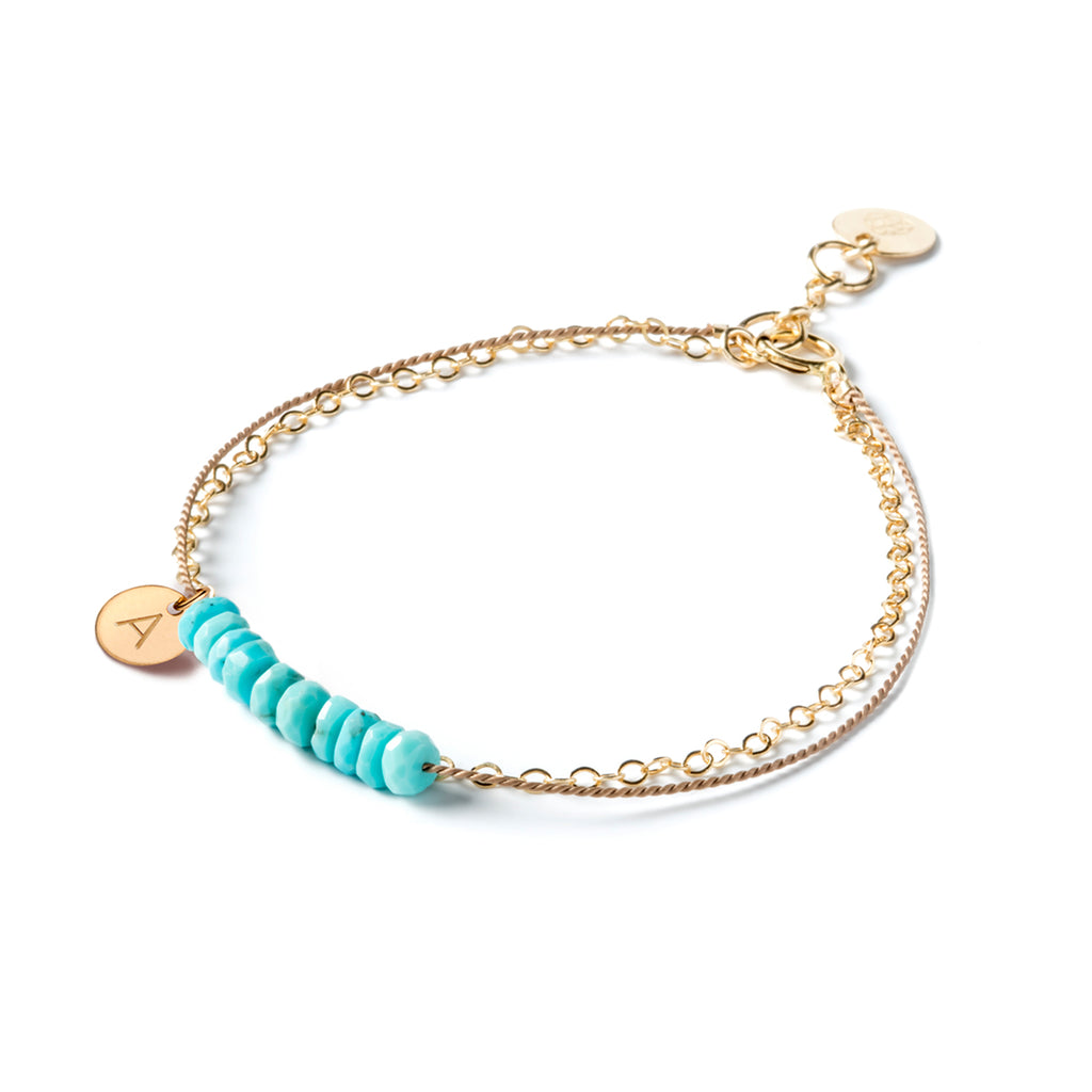Wanderlust Life Ethically Handmade jewellery made in the UK. Minimalist gold and fine cord jewellery. 14k gold & silk turquoise beaded bracelet personalised with a single initial tag. 