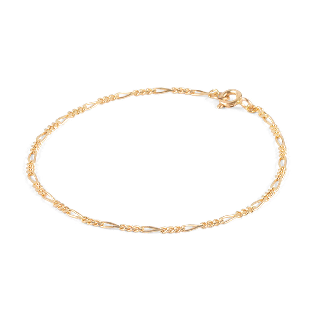 Wanderlust Life Sofia Figaro Chain Solid Gold Bracelet. A traditional style Figaro chain with circular links and alternating oval links at regular intervals. A masculine profile, solid gold bracelet. Designed, handcrafted and hallmarked in the UK.