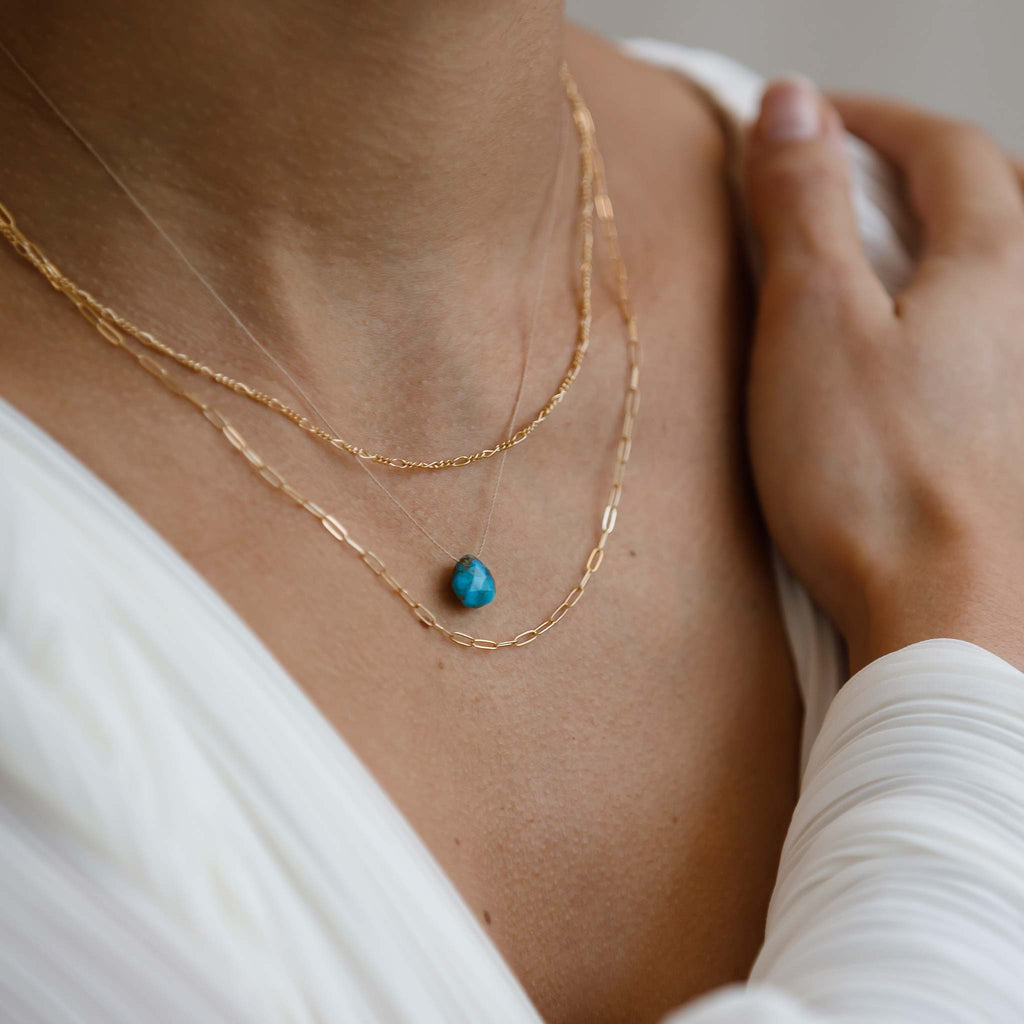 The Sylvie Layering Chain is an adjustable paperclip link chain. Styled in a necklace stack with the Sofia Figaro Necklace and Mohave Turquoise Fine Cord.