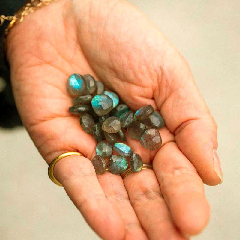 Our jewellery maker Bex cupping a hand full of labrodorite semi-precious gemstones. 