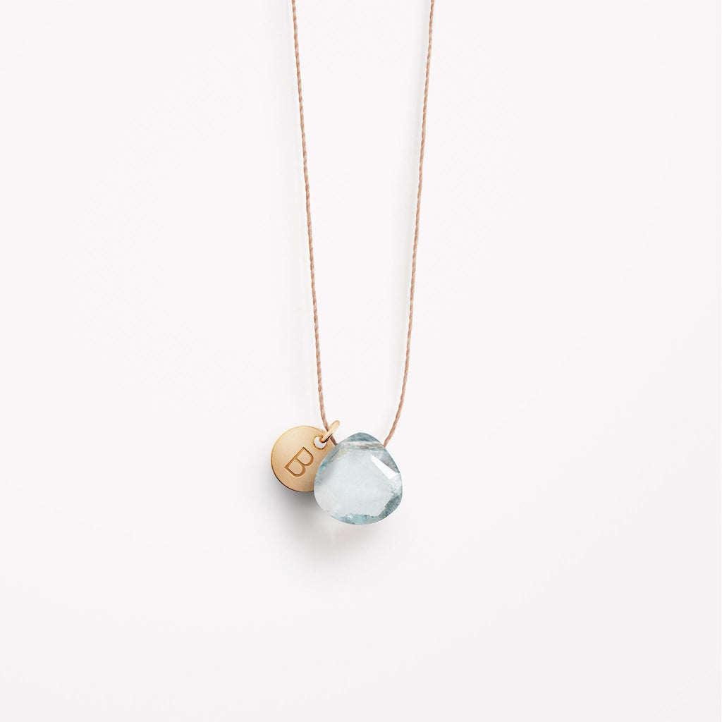 Wanderlust Life Ethically Handmade jewellery made in the UK. Minimalist gold and fine cord jewellery. Personalised aquamarine gemstone fine cord necklace with gold personalised tag.