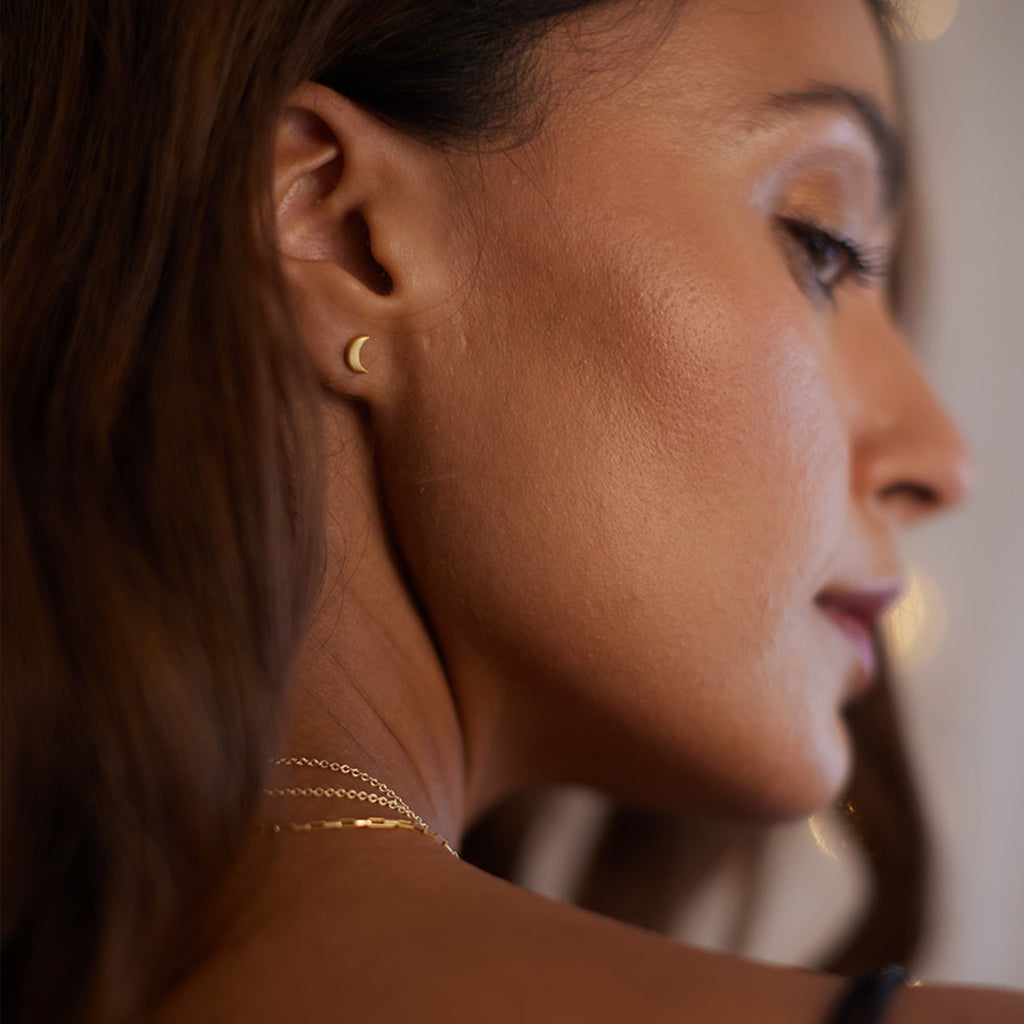 Wanderlust Life Luna crescent moon studs. Proudly designed in Devon, taking their shape from the inspiration of celestial bodies. Handcrafted by Wanderlust Life global artisan partners using 14k gold vermeil on 925 sterling silver.