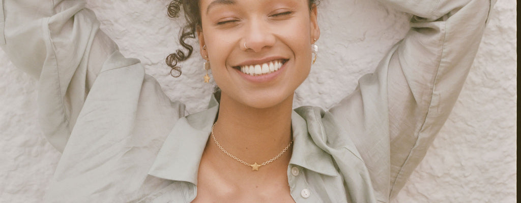 Wanderlust Life Jewellery, shop up to 30% off in our sale. Model wears the Star Wish Amulet Chain Choker necklace, a starfish charm hangs in the centre of this choker necklace.