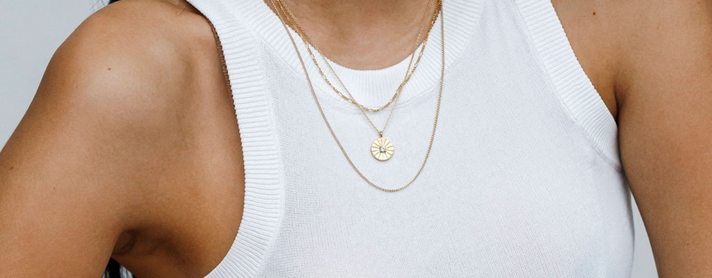 Wanderlust Life Jewellery luxe Birthstone Collection, designed in Devon and handcrafted with gold vermeil and gold fill. Model wears Birthstone Sundial Necklace.