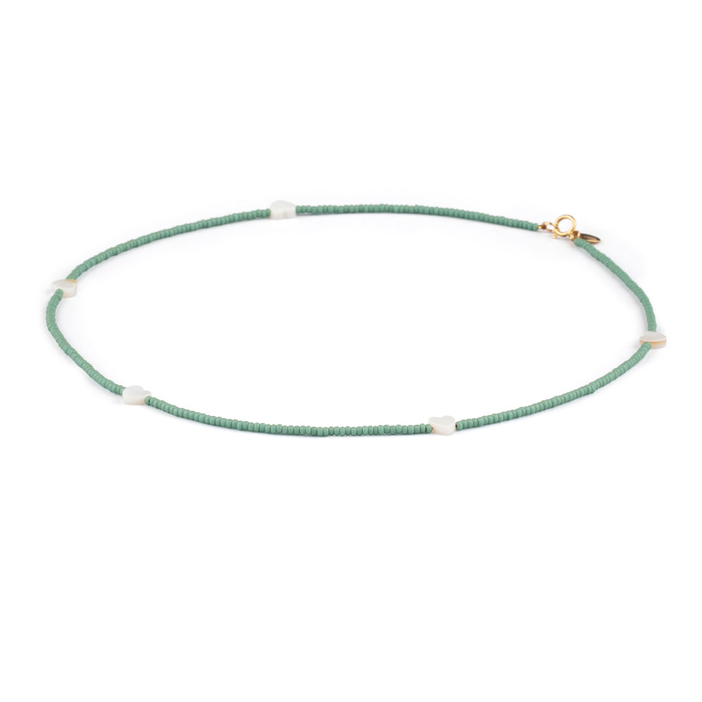 Featuring seed beads in cloudy sky blue, our beaded necklace is interspersed with mother of pearl heart charms, designed to layer, love, and wear on repeat.