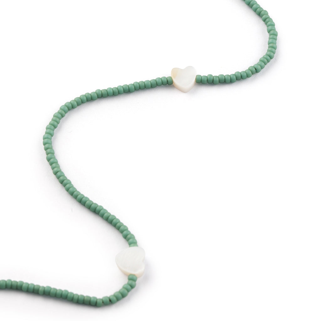 Featuring seed beads in cloudy sky blue, our beaded necklace is interspersed with mother of pearl heart charms, designed to layer, love, and wear on repeat.