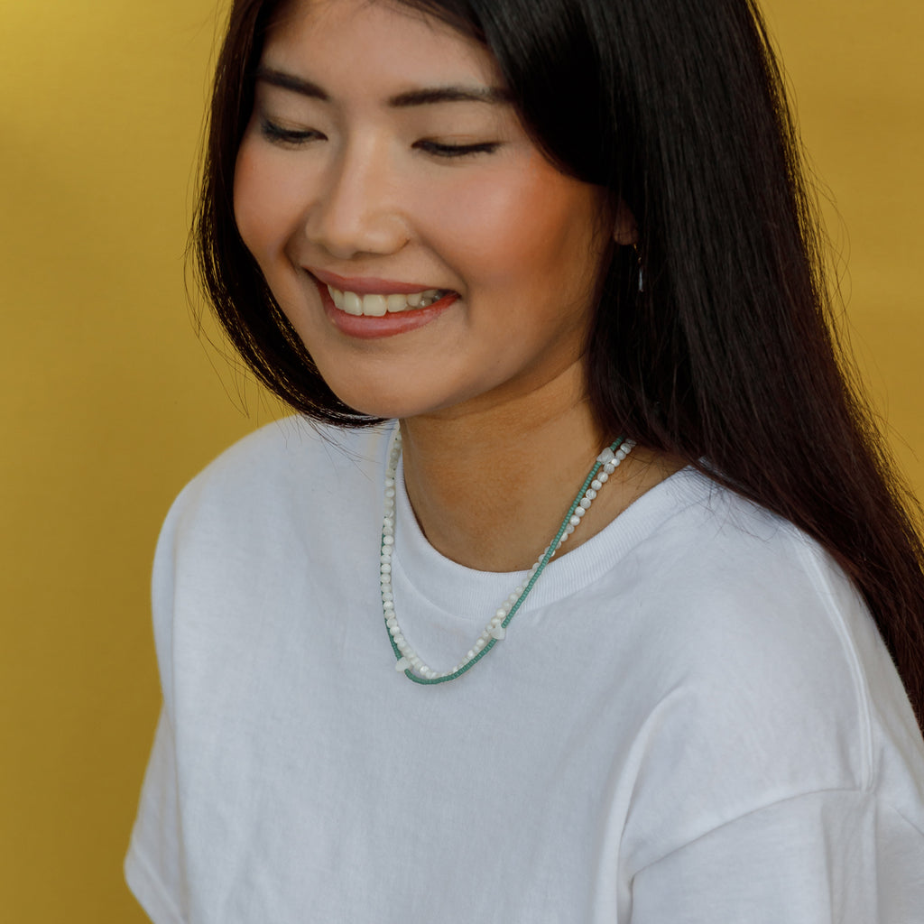 Featuring seed beads in cloudy sky blue, our beaded necklace is interspersed with mother of pearl heart charms, designed to layer, love, and wear on repeat.
