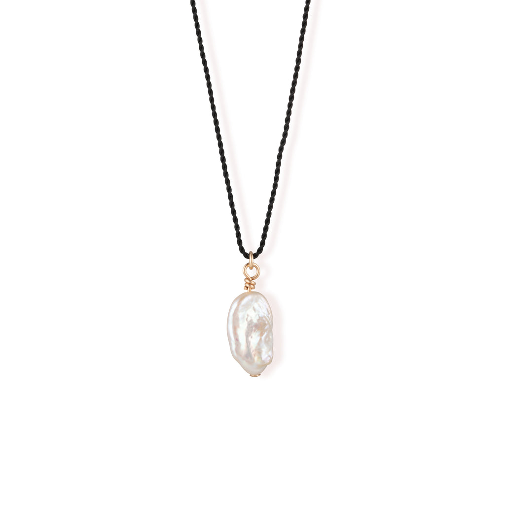 A single freshwater “Kiwa” shaped pearl strung on a black silk cord - a striking twist on our signature fine cord necklaces. 
