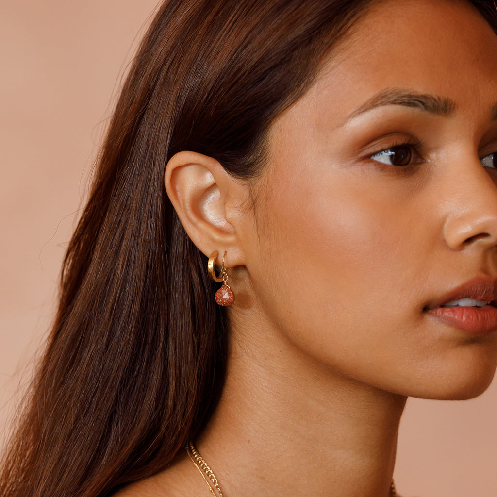 Leopard Jasper in our signature faceted shape hangs from a minimalist gold ear wire for an effortless, laid-back look. Styled with the minimal gold Zanya hoops.