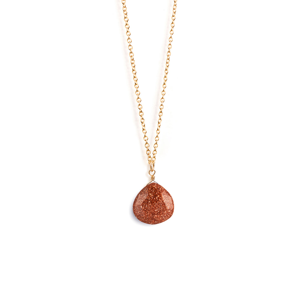 A radiant man-made glass goldstone with copper sparkles reminiscent of a miniature glitterball hangs from a minimal gold-fill chain. Designed and handcrafted in Devon.