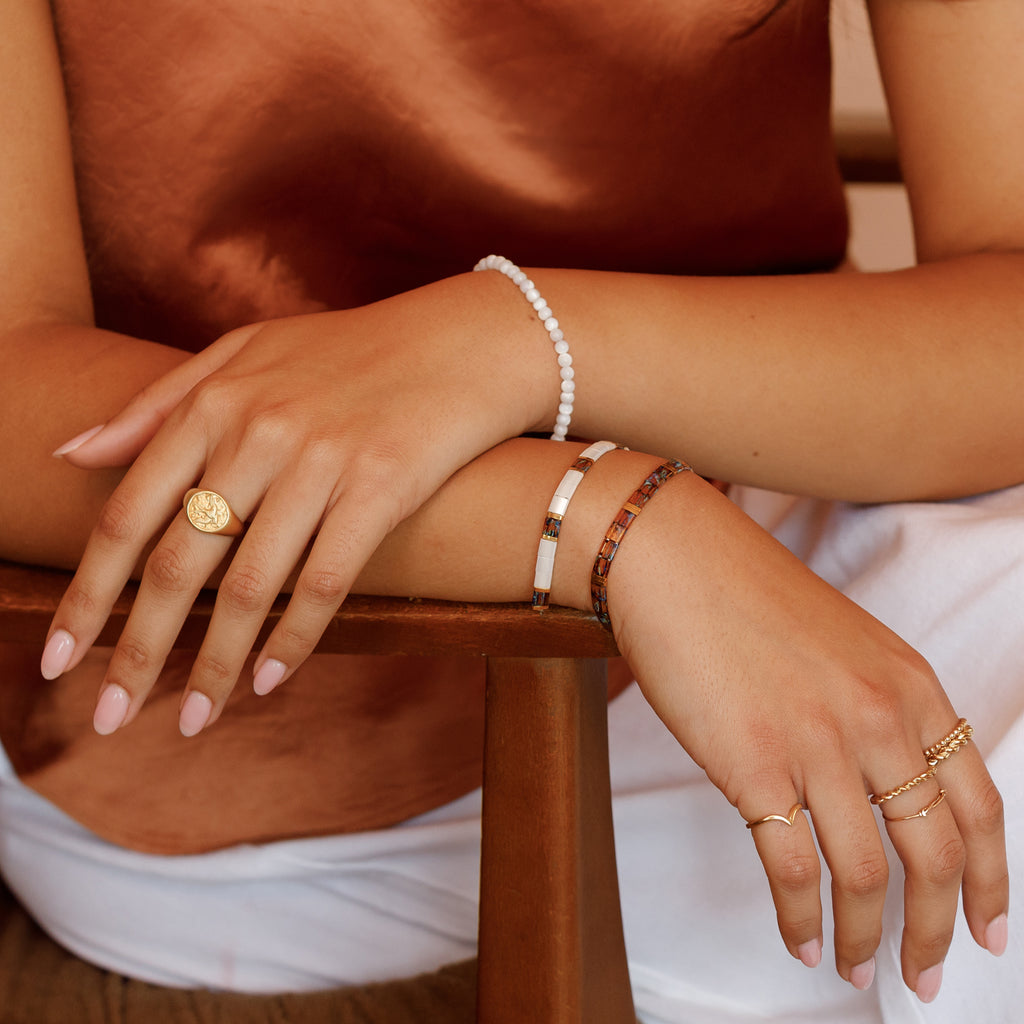 A bracelet combination of the Kikko Layering Bracelet, Coco Mosaic Slider Bracelet and the Kai Beaded Bracelet.