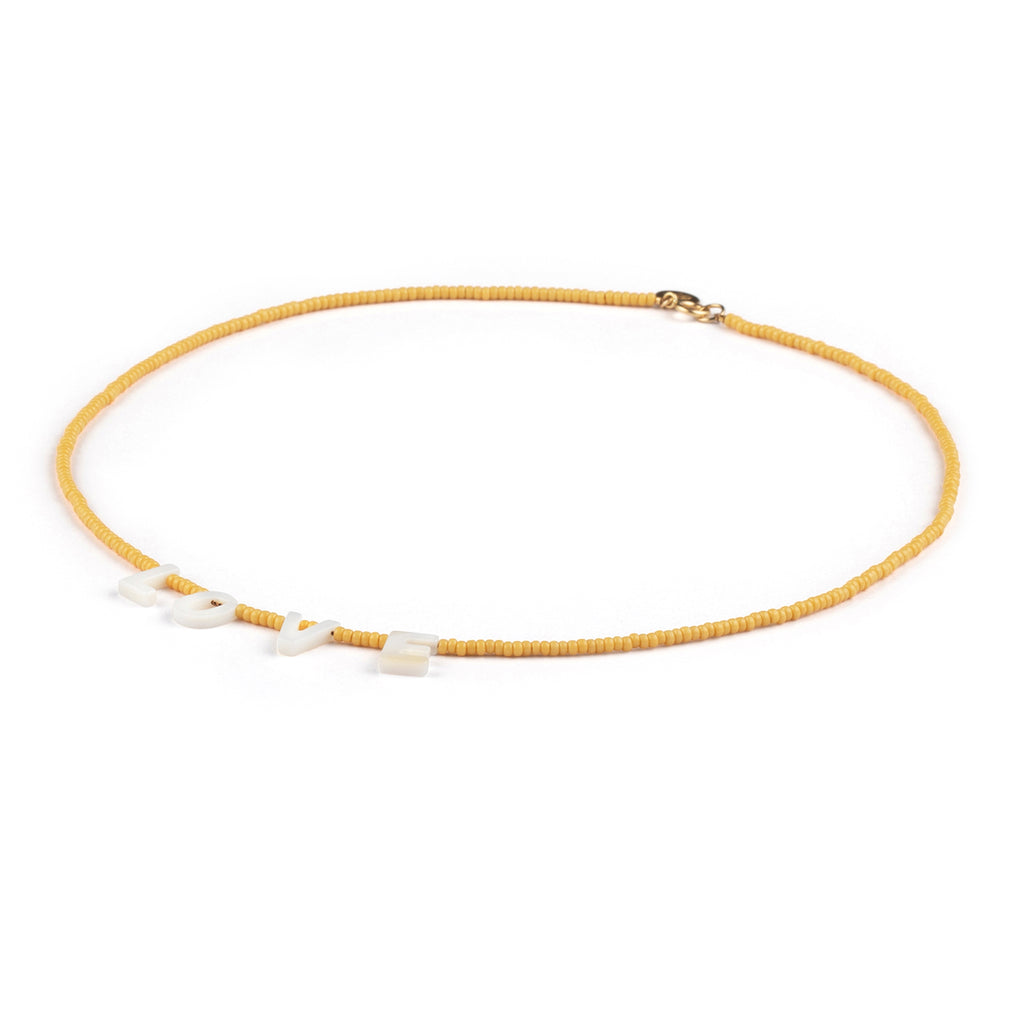 Featuring seed beads in sun-soaked lemon, our beaded necklace showcases mother-of-pearl letters that spell out L-O-V-E. 
