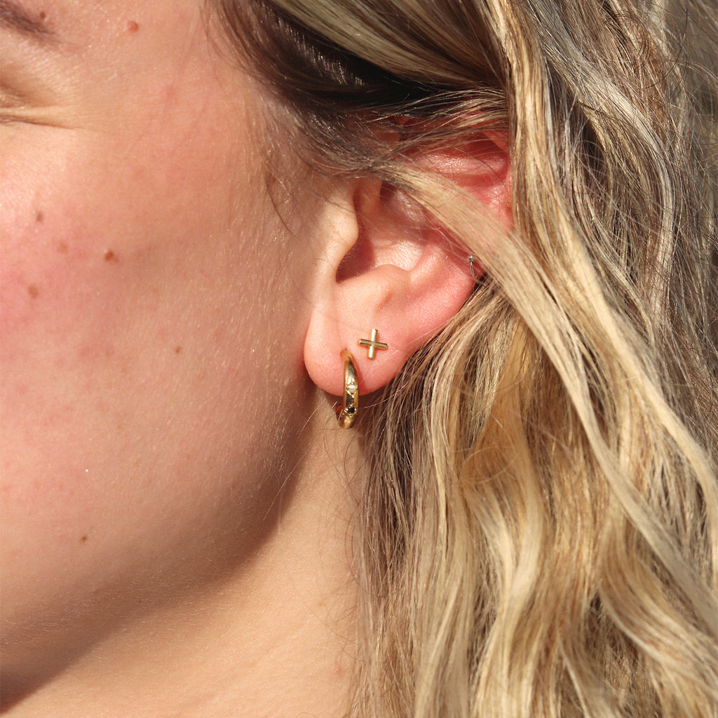 Lovestud Earring. Simple gold plated silver studs take the shape of the sweet symbol of a kiss. Proudly designed in Devon & crafted by our Wanderlust Life artisan partners