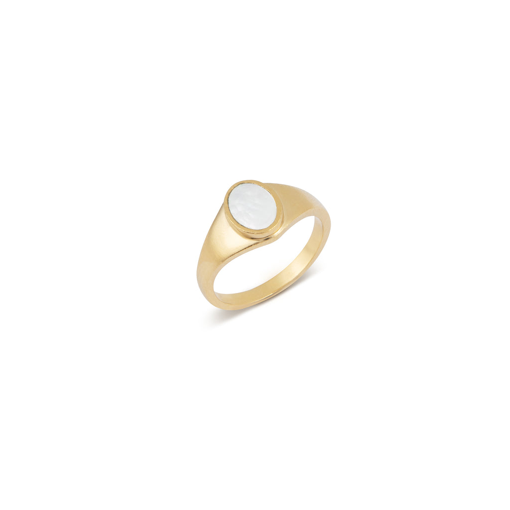 This statement ring features a luminous oval of Mother of Pearl, cradled at the centre of a thick gold band