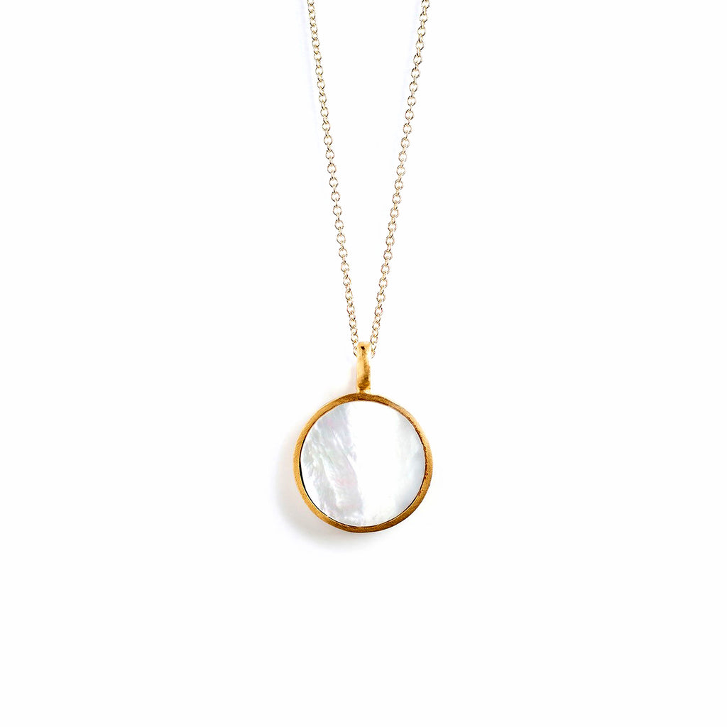 A circular pendant features a disc of mother of pearl, reminiscent of light flooding through a porthole.