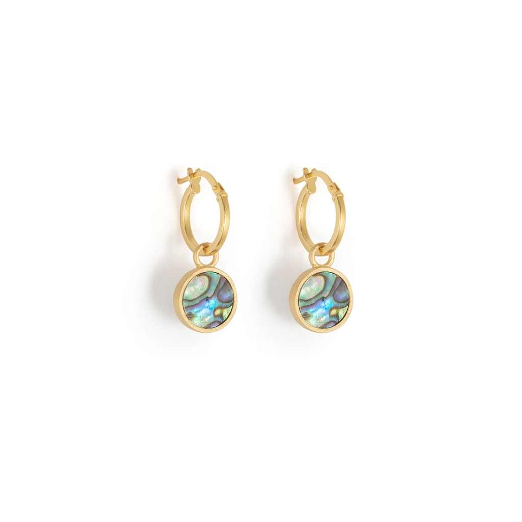A glowing slice of paua shell is framed in brushed gold to create these bestselling portilla hoop earrings.