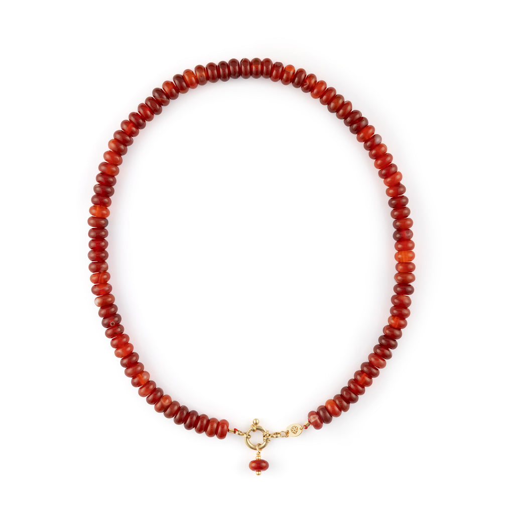  Chunky Red Agate gemstones on a doughnut beaded necklace with a golden ring fastening like a ship’s wheel, designed to sit front and centre. 