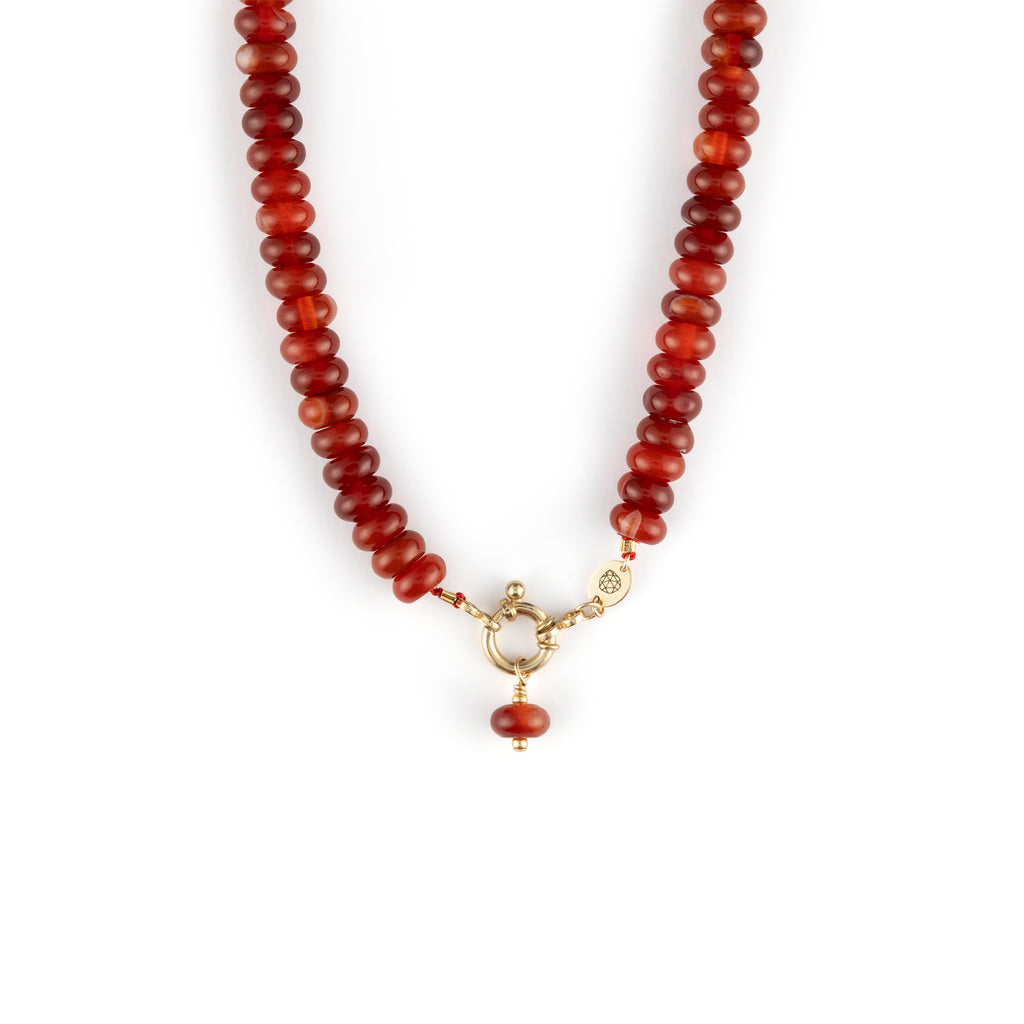  Chunky Red Agate gemstones on a doughnut beaded necklace with a golden ring fastening like a ship’s wheel, designed to sit front and centre. 