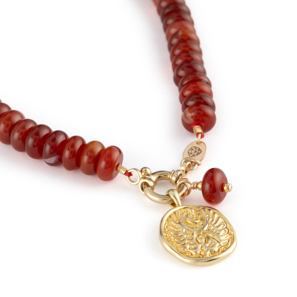  Chunky Red Agate gemstones on a doughnut beaded necklace with a golden ring fastening like a ship’s wheel, designed to sit front and centre. Featuring Libra Zodiac Coin Pendant.
