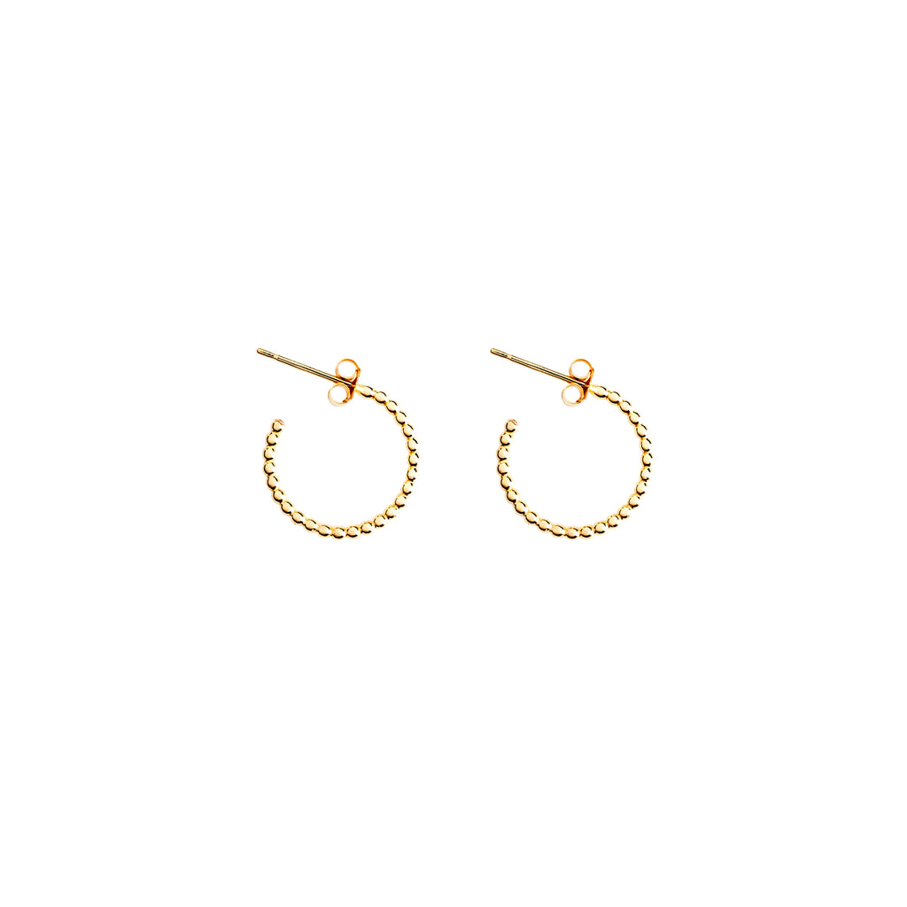 Solstice petite gold hoop earring. A series of miniature gold orbs form a tiny huggie hoop that delicately encloses the lobe. Proudly designed in Devon & handcrafted by our Wanderlust Life global artisan partners.
