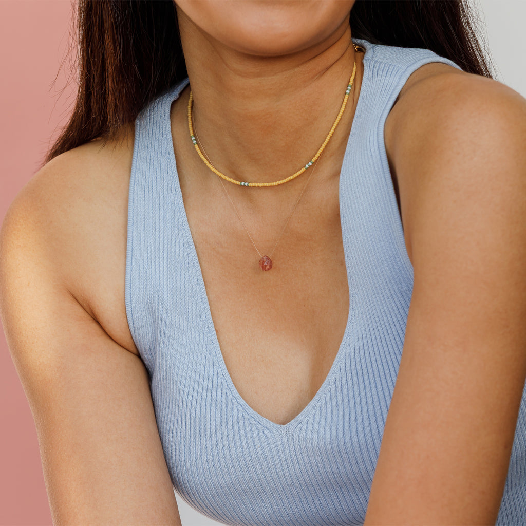 Featuring a minimalist pattern of yellow, green and white beads, a bold and mood-boosting choker necklace.