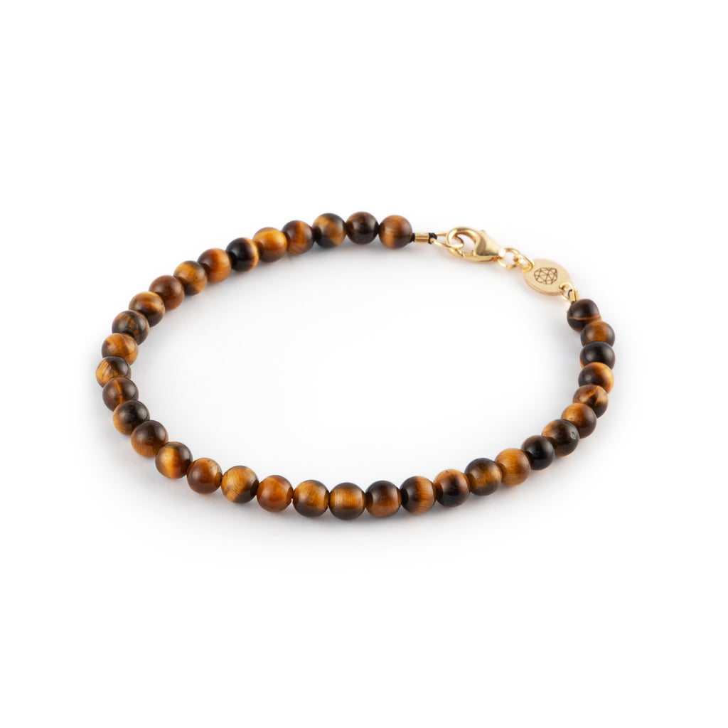 The Āina bracelet is a golden-hued strand of Tiger’s Eye beads.