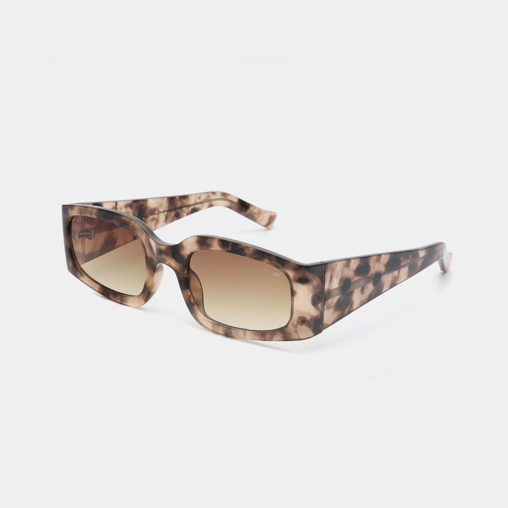 These sunglasses feature a mottled pattern in neutral colours across the frame, with yellow, light toned frames. They’re soft and edgy with angled and linear frames to combine a casual feel with more statement sunglasses.