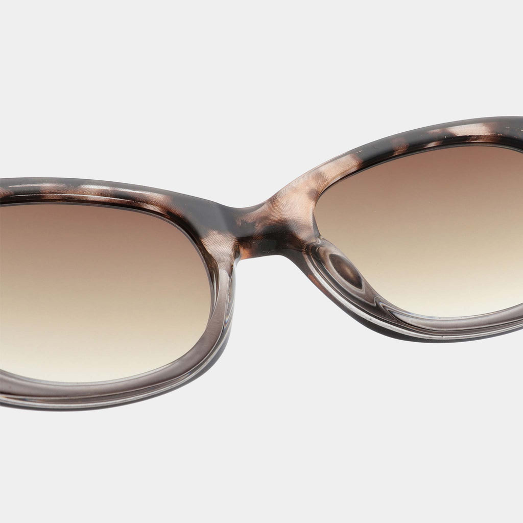 Anma is medium sized style with a rounded frame with more body along the side of the frames, which gives a powerful and strong expression. They feature a mottled pattern in neutral tones, with light sepia lenses.