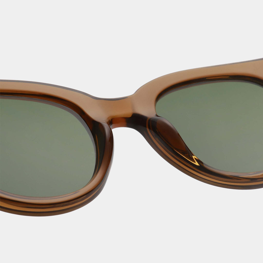 Designed in Copenhagen by A.Kjaerbede, Lilly is a bold and modern take on a classic, rounded style. With smokey green and brown frames and green lenses, these sunglasses offer UV 400 protection.
